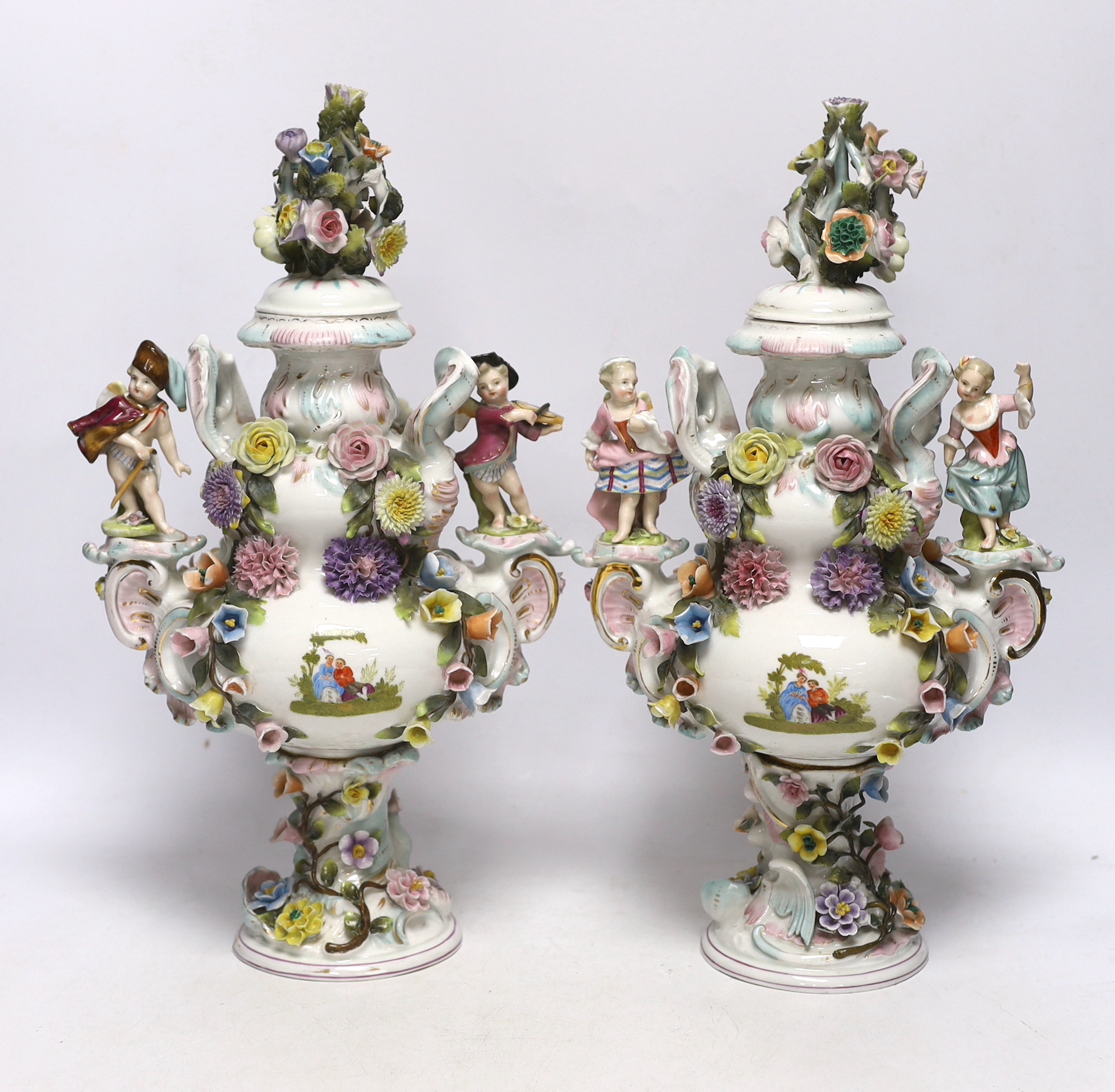 A pair of Sitzendorf floral encrusted and figural vases and covers, late 19th century, 36cm high